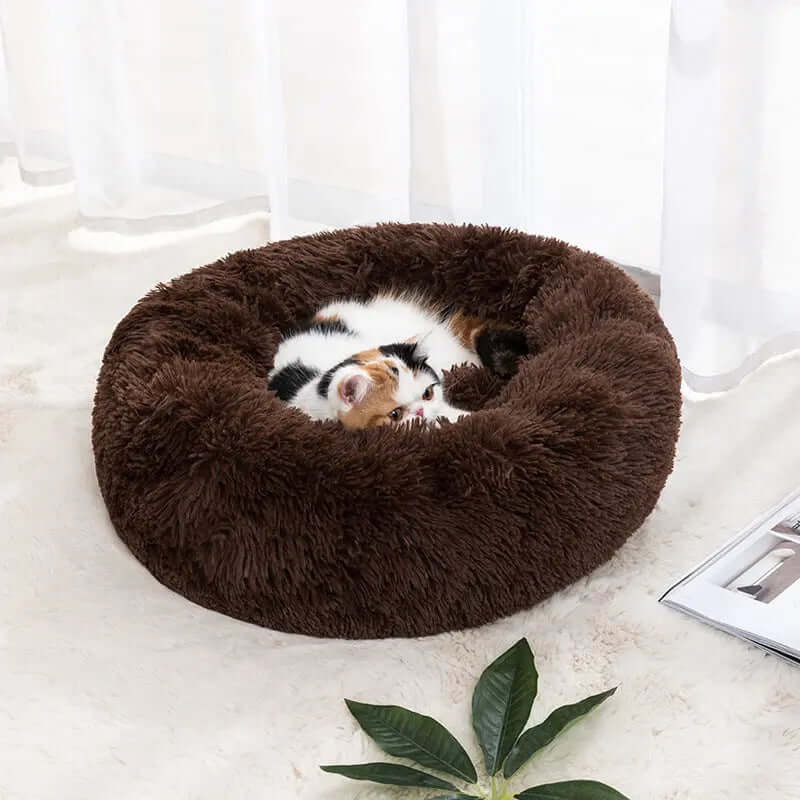 Cozy brown winter warm pet bed with a cat sleeping inside.