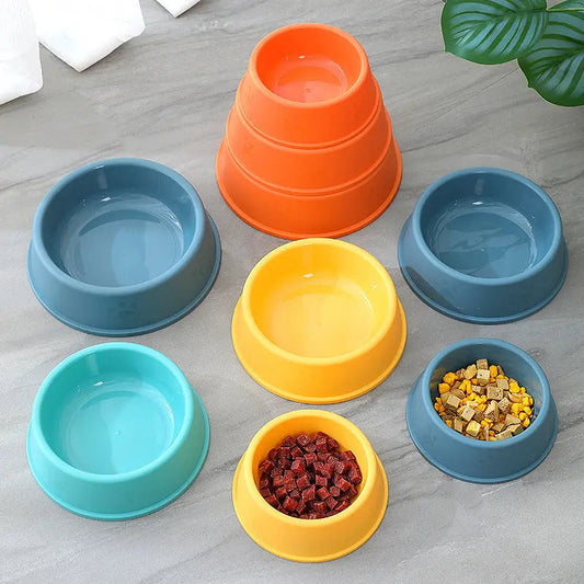 Pet bowls in various sizes and colors including blue, green, yellow, and orange, made of plastic with frosted footprints design.