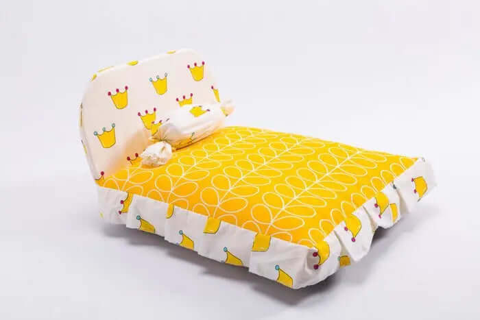 Pet House Puppy Bed with stylish yellow and white pattern, featuring a candy-shaped pillow.