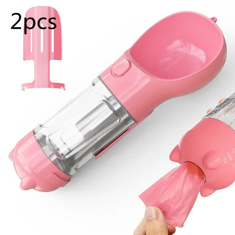 Portable pink pet water bottle with feeder bowl and garbage bag storage, ideal for on-the-go pet care.