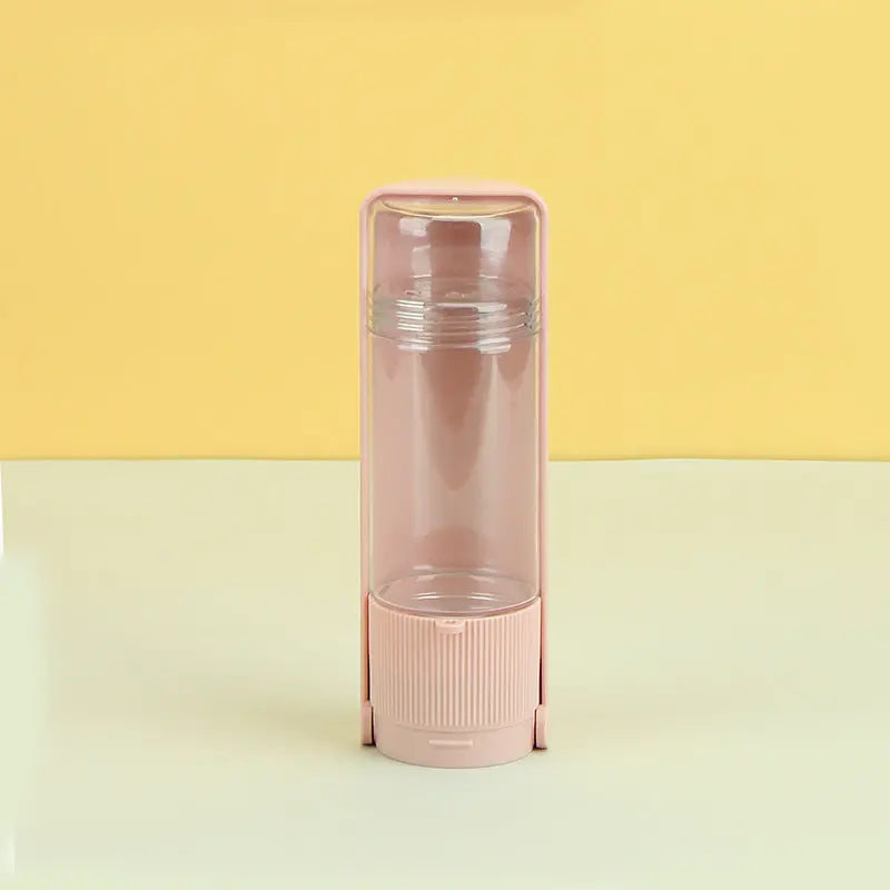 Portable pet water bottle with pink design; ideal for outdoor dog hydration.