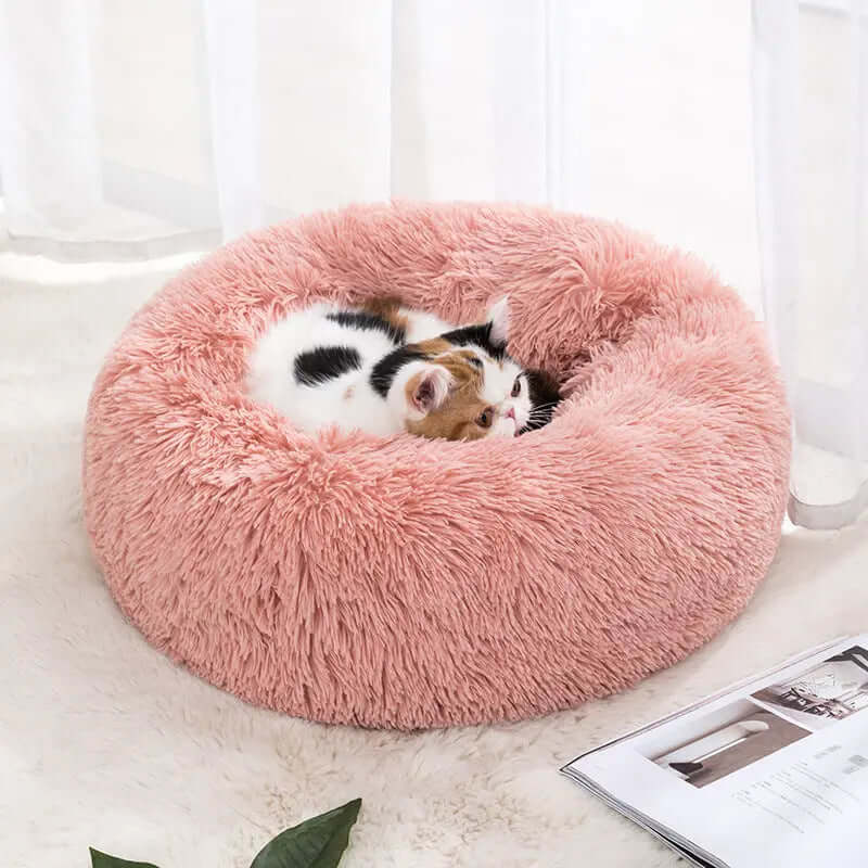 Winter warm pet bed for cats, soft pink fabric, cozy design.