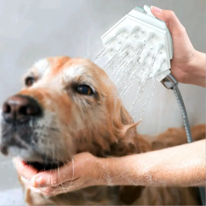 Pet shower brush nozzle used on a dog for bathing and massage.