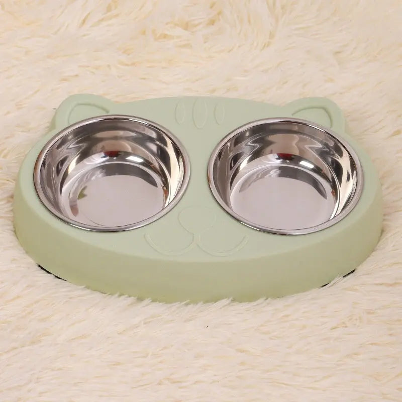 Stainless steel cat bowl with green base, suitable for feeding and watering.