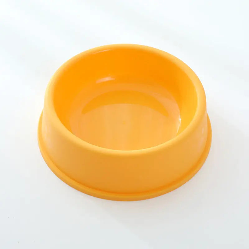 Yellow plastic pet bowl with frosted paw prints design, suitable for dogs and cats.