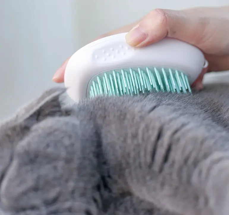 White cat hair brush made of ABS material in use.