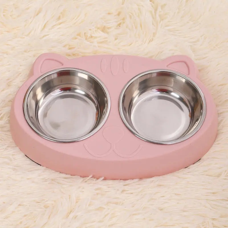 Pink cat face stainless steel pet bowl for feeding and drinking.