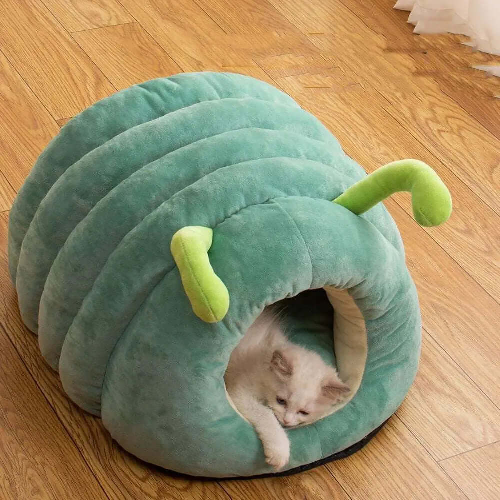 Green caterpillar-shaped plush pet bed with a cat inside.