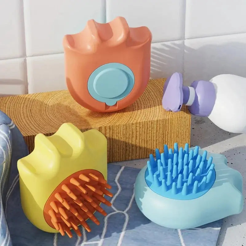 Pet bath brush for cats and dogs in assorted colors on bathroom surface.