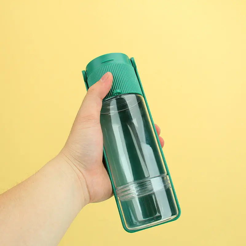 Portable pet water bottle in hand, ideal for travel.