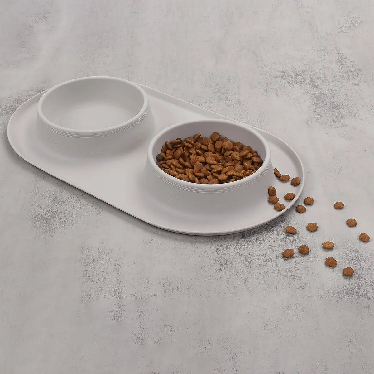 Light gray silicone pet feeding bowl set with two compartments for food.